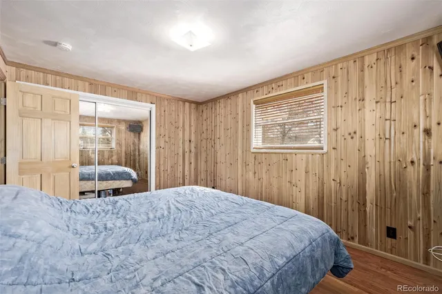 a bedroom with a large bed and a window