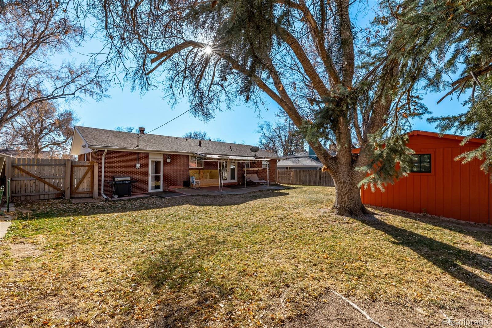 8227 Depew Way Arvada, CO 80003 - Photo 29 of 31 a view of a house with a large tree and a yard