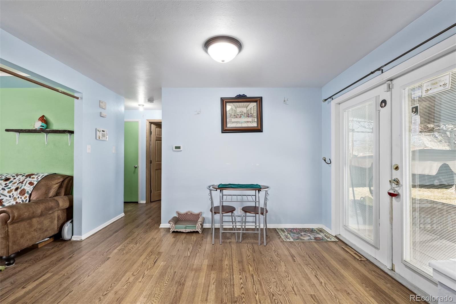 8227 Depew Way Arvada, CO 80003 - Photo 9 of 31 a work room with furniture and wooden floor
