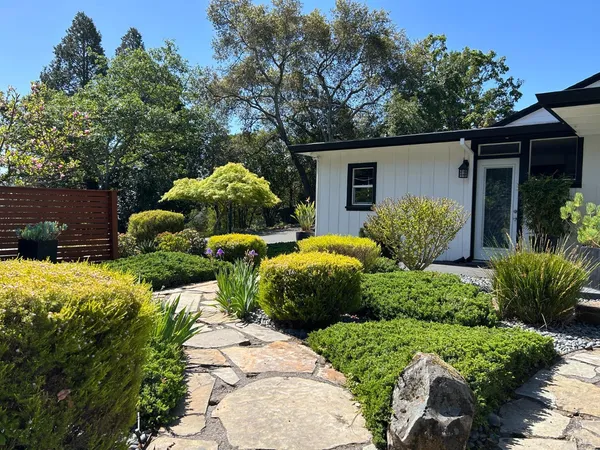a view of two house with a yard and a garden