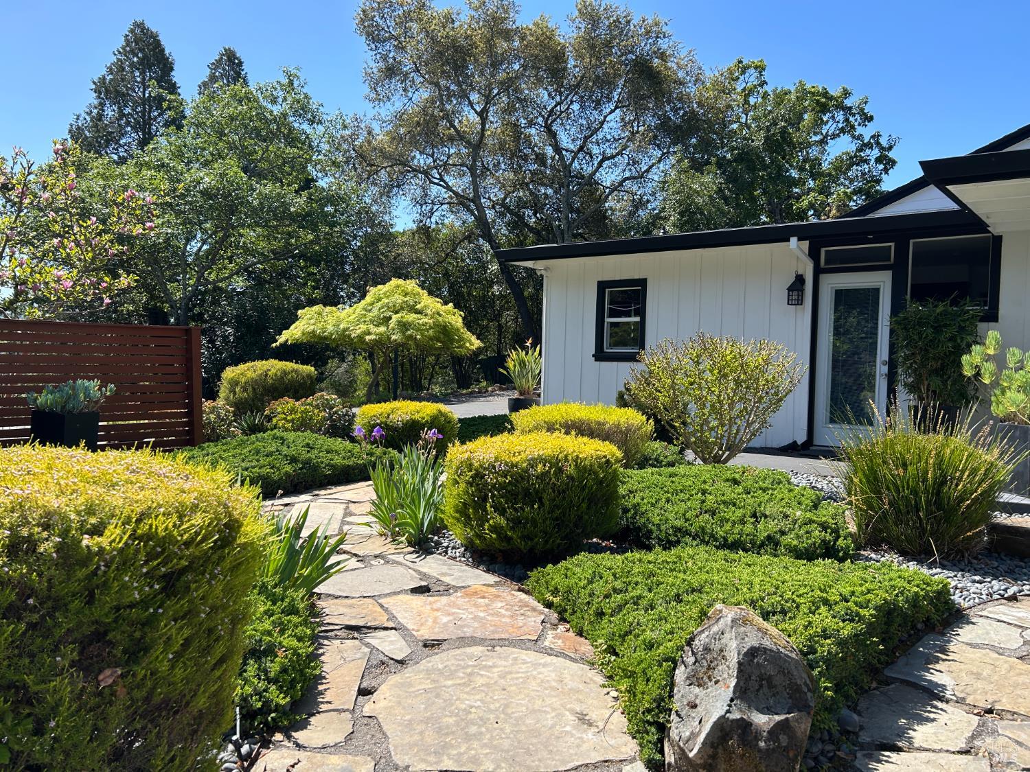 a view of two house with a yard and a garden