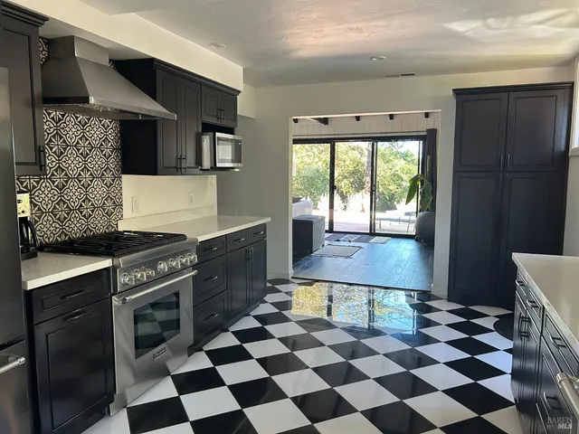 a kitchen with a stove a sink and a refrigerator