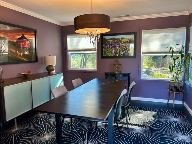a view of a dining room with furniture and window