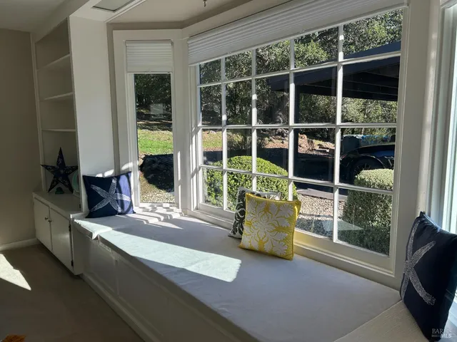 a bed sitting in a bedroom next to a window