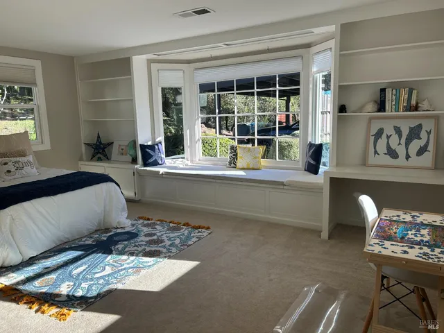 a bedroom with a bed and a couch