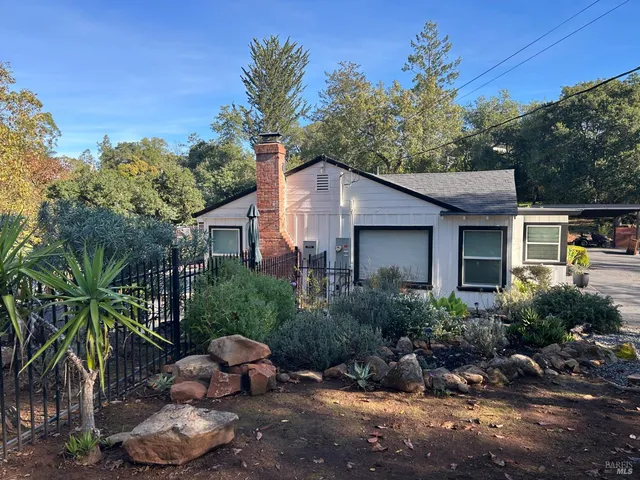 a view of a backyard with large trees