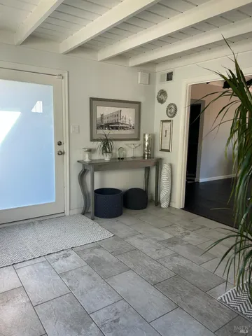 a view of kitchen with furniture and refrigerator