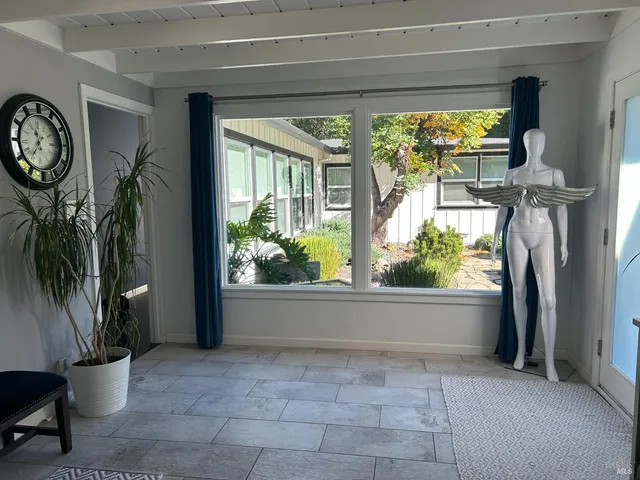 a view of a porch with furniture and a potted plant