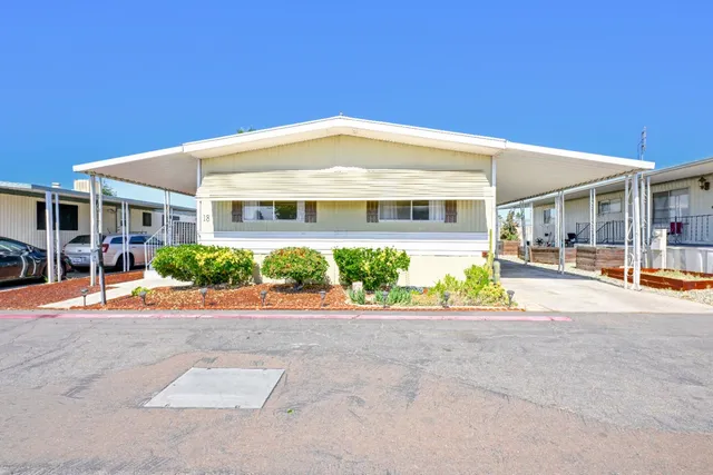 a front view of a building with potted plants
