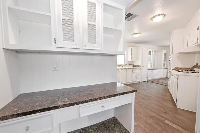 a kitchen with a stove a sink dishwasher and a refrigerator