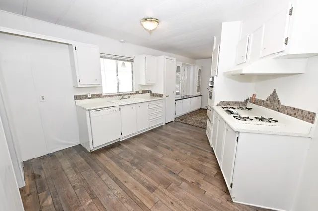 an empty room with fan and windows