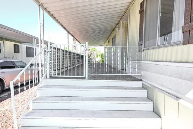 a view of a bedroom with a ceiling fan and window