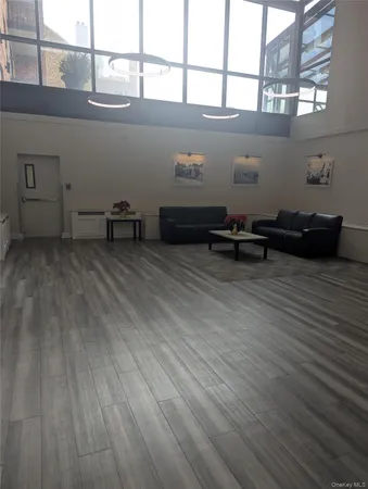 a view of a room with wooden floor and a window