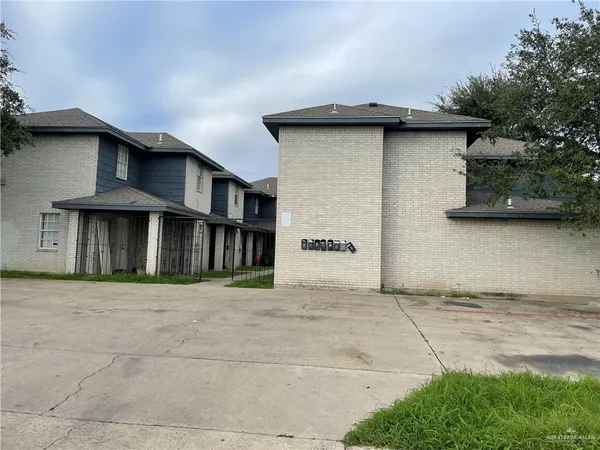 a front view of a house with plants