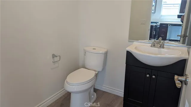 a bathroom with a sink toilet and a mirror