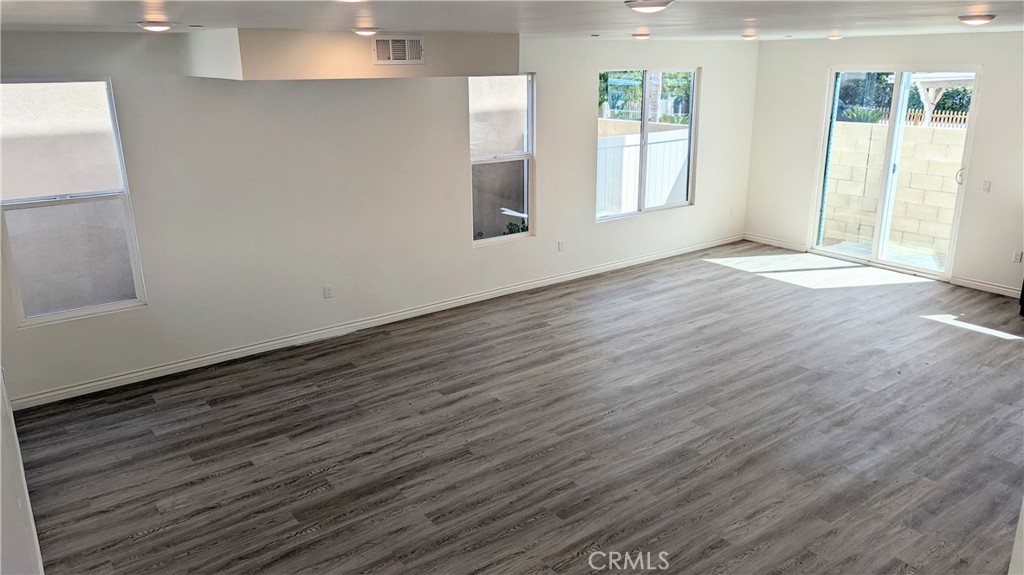 15115 Logos Court North Hills, CA 91343 - Photo 21 of 21 an empty room with wooden floor and windows