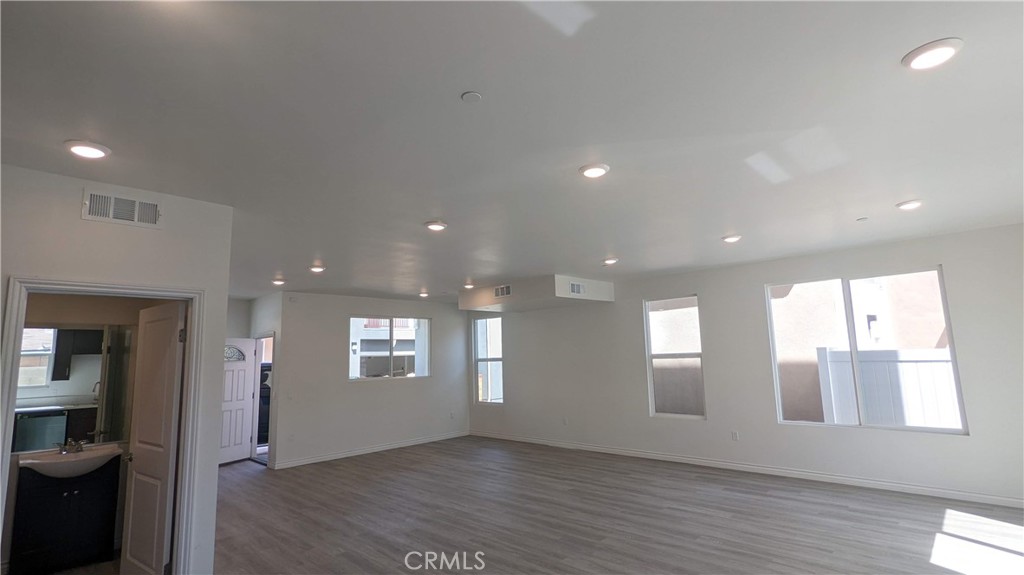 15115 Logos Court North Hills, CA 91343 - Photo 10 of 21 a view of an empty room with wooden floor and a window