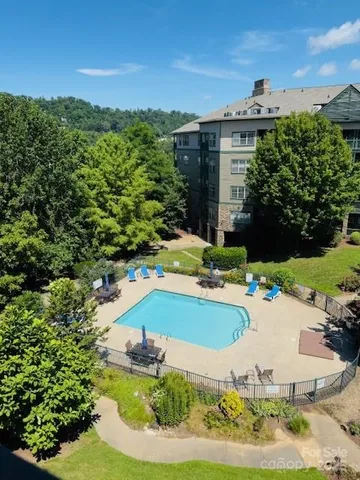 a view of a swimming pool with a yard