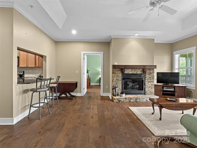 a living room with furniture a fireplace and a flat screen tv
