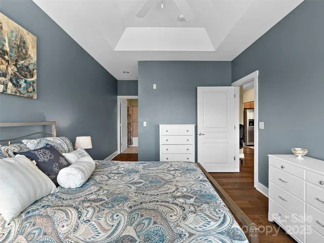 a bedroom with a large bed and a dresser