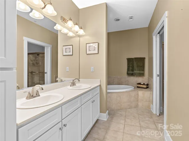 a bathroom with a granite countertop sink a toilet a mirror and shower