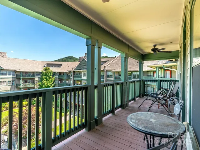 a view of a balcony with furniture and garden