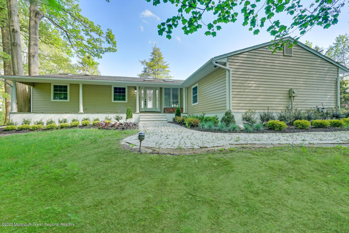 236 Holland Road Holmdel, NJ 07733 - Photo 2 of 42 a front view of a house with a garden
