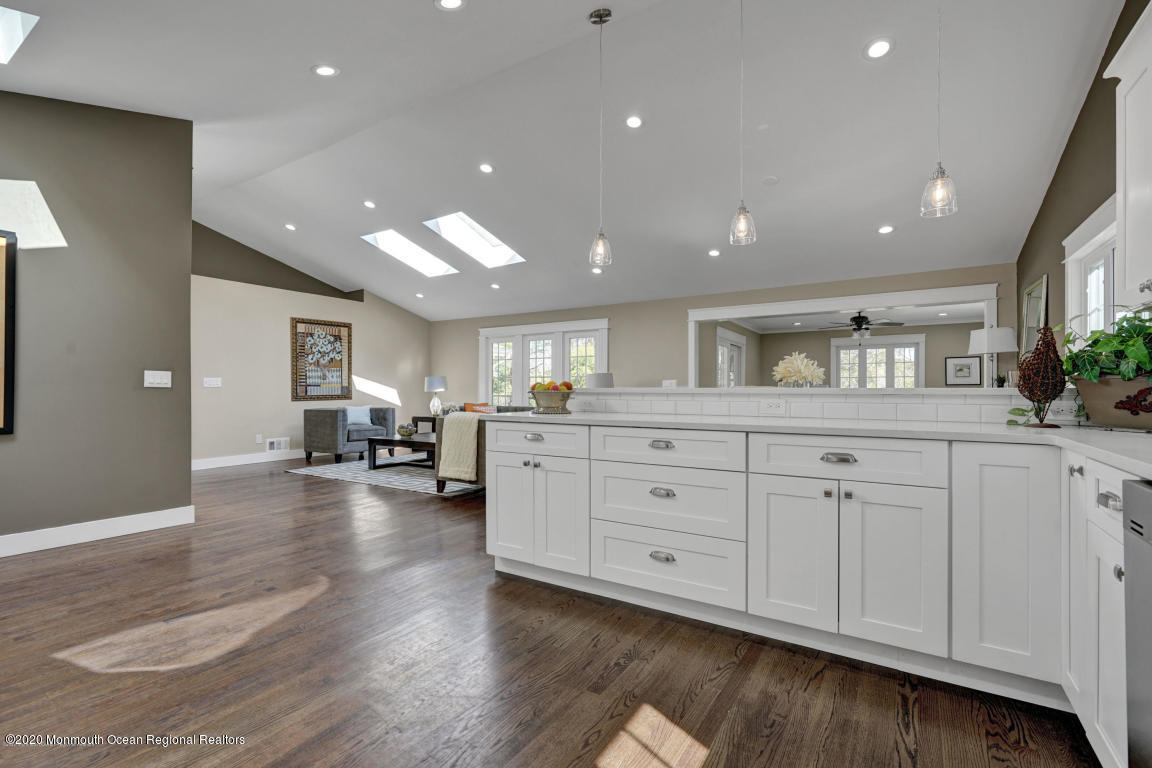 236 Holland Road Holmdel, NJ 07733 - Photo 13 of 42 a open hall with white cabinets and wooden floor
