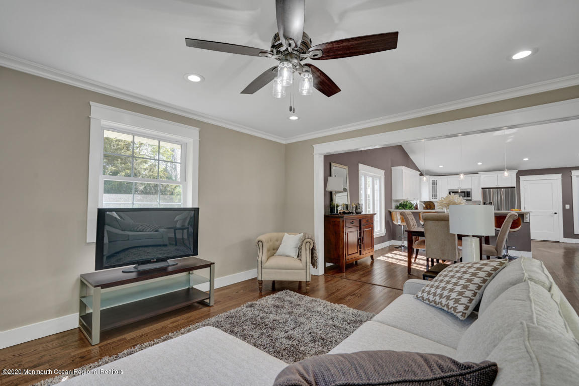 236 Holland Road Holmdel, NJ 07733 - Photo 18 of 42 a living room with furniture and a flat screen tv