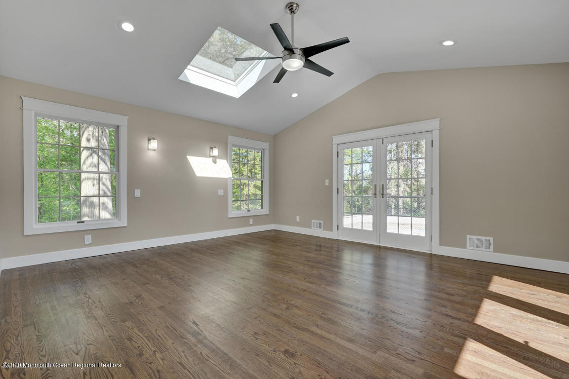 236 Holland Road Holmdel, NJ 07733 - Photo 20 of 42 a view of an empty room with wooden floor and a window