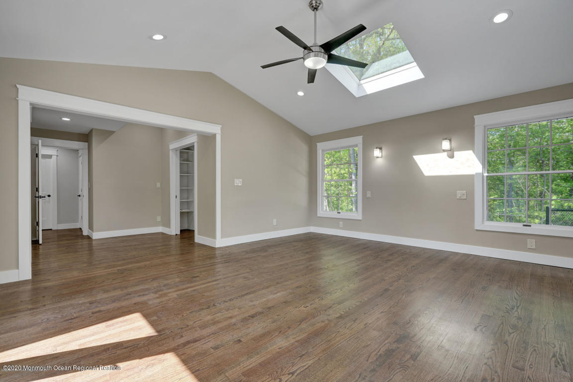 236 Holland Road Holmdel, NJ 07733 - Photo 22 of 42 an empty room with wooden floor and windows