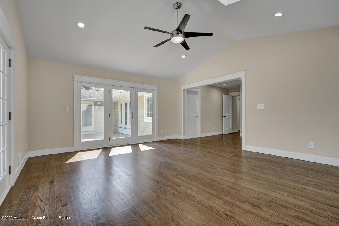 236 Holland Road Holmdel, NJ 07733 - Photo 23 of 42 a view of an empty room with wooden floor and a window