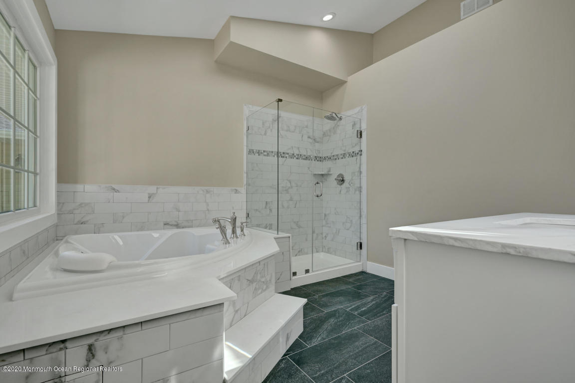 236 Holland Road Holmdel, NJ 07733 - Photo 25 of 42 a bathroom with a sink a toilet and shower