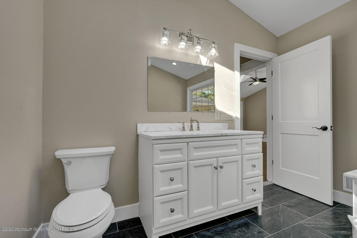 236 Holland Road Holmdel, NJ 07733 - Photo 27 of 42 a bathroom with a toilet sink and mirror