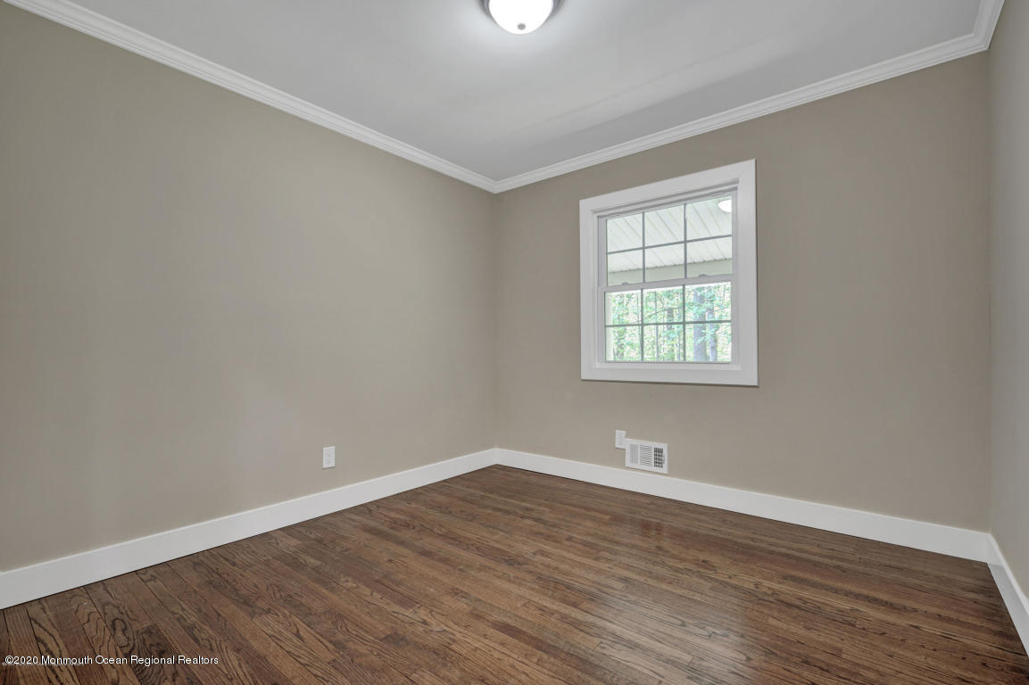 236 Holland Road Holmdel, NJ 07733 - Photo 30 of 42 wooden floor in an empty room with a window