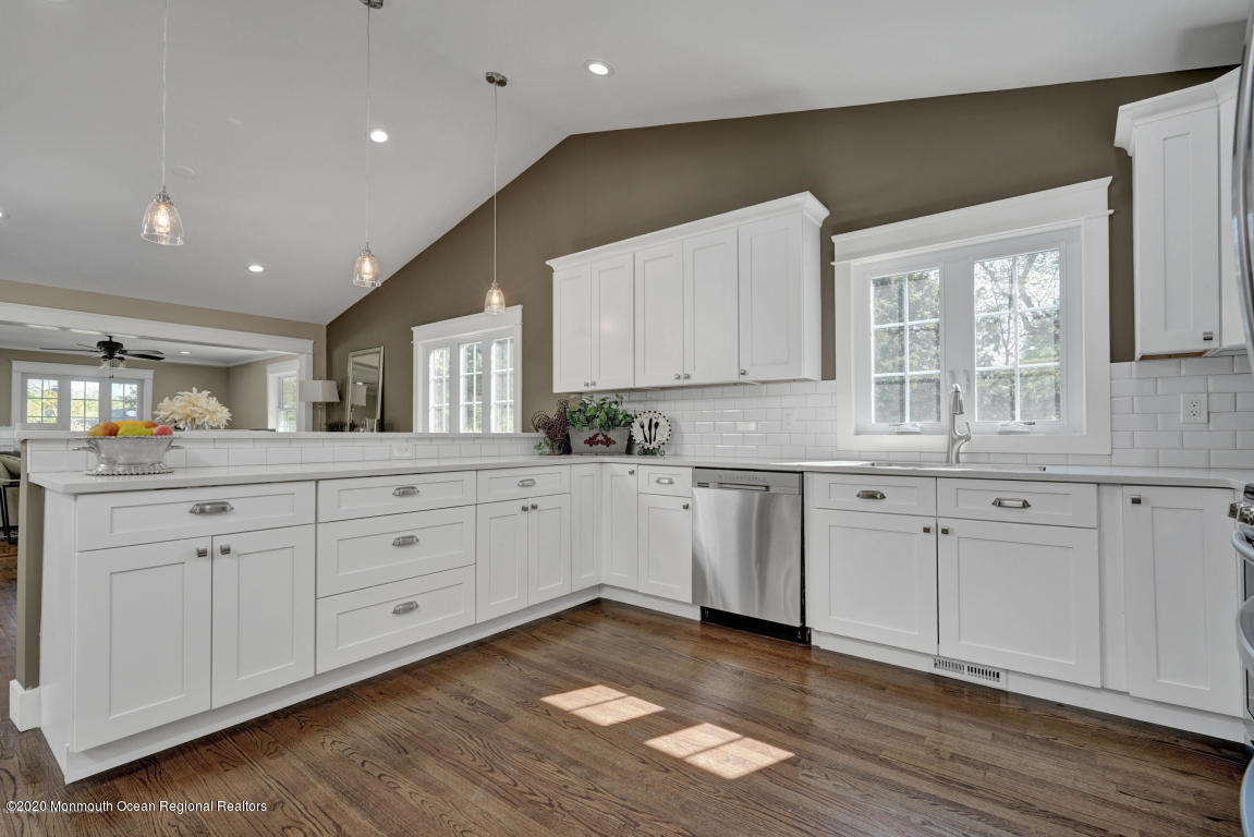 236 Holland Road Holmdel, NJ 07733 - Photo 4 of 42 a kitchen with white cabinets with wooden floor and window
