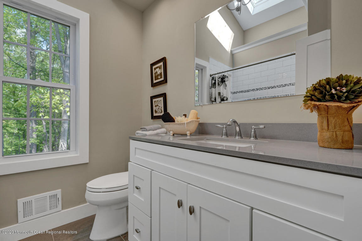 236 Holland Road Holmdel, NJ 07733 - Photo 32 of 42 a bathroom with a granite countertop sink and a toilet