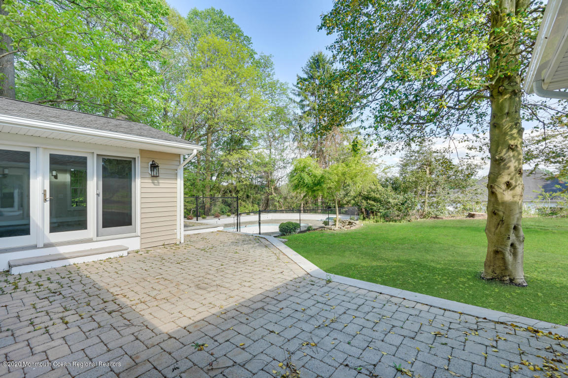 236 Holland Road Holmdel, NJ 07733 - Photo 36 of 42 a front view of a house with a garden