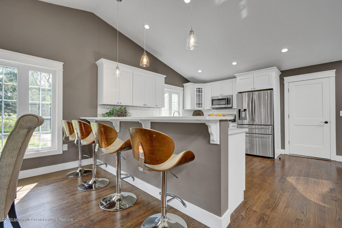 236 Holland Road Holmdel, NJ 07733 - Photo 7 of 42 a kitchen with granite countertop kitchen island stainless steel appliances a table and chairs in it