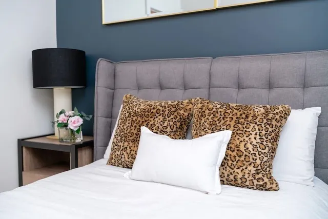 a bedroom with a bed and a lamp