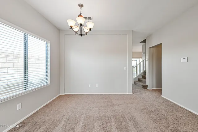 a view of a chandelier in big room and chandelier