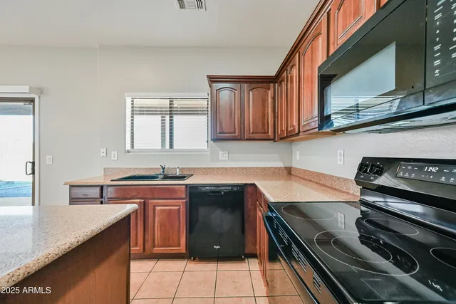 a kitchen with stainless steel appliances granite countertop a stove and a sink