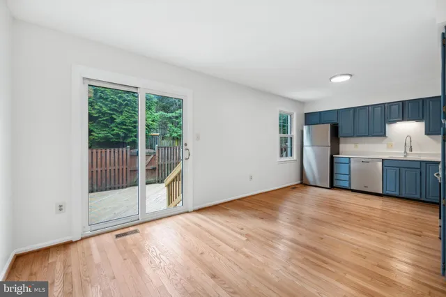 a view of a kitchen with wooden floor and electronic appliances