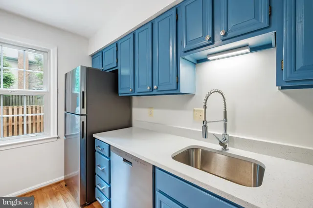 a kitchen with stainless steel appliances granite countertop a refrigerator and a sink