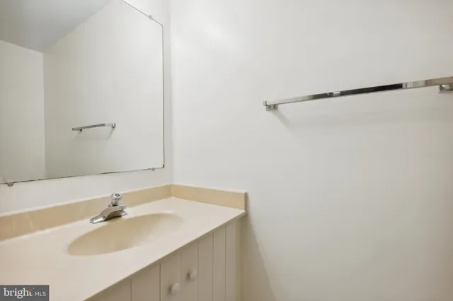 a bathroom with a sink and a white cabinet