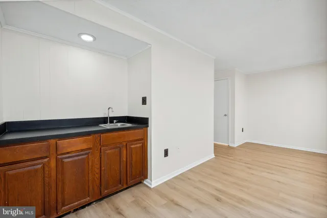a view of storage and utility room with wooden floor