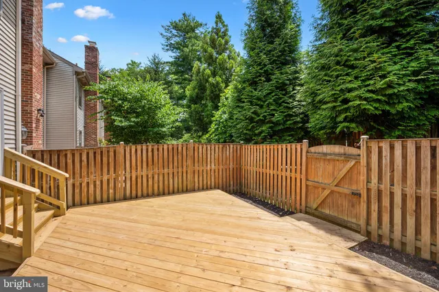 a view of wooden fence and trees
