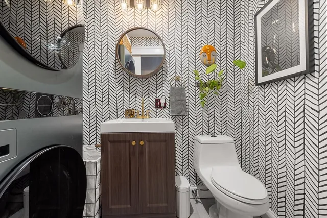 a bathroom with a toilet a sink and mirror