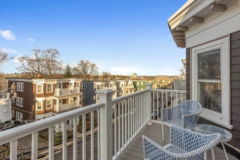 24 Thelma Road, Unit PH Boston, MA 02122 - Photo 15 of 17 a view of a balcony with wooden chairs
