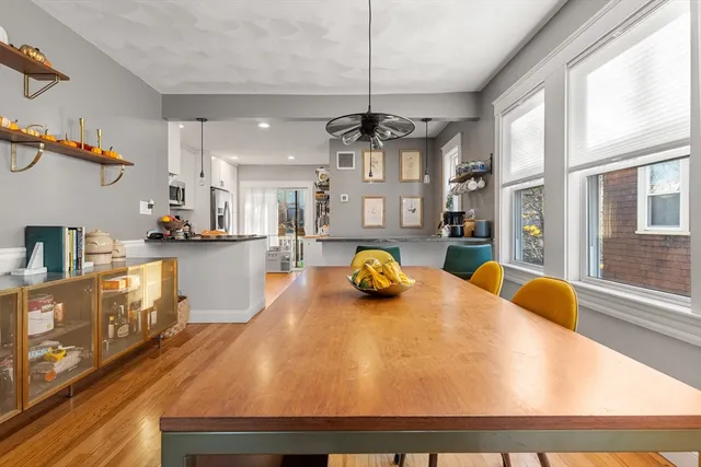a kitchen with stainless steel appliances granite countertop a sink a stove and a wooden floors